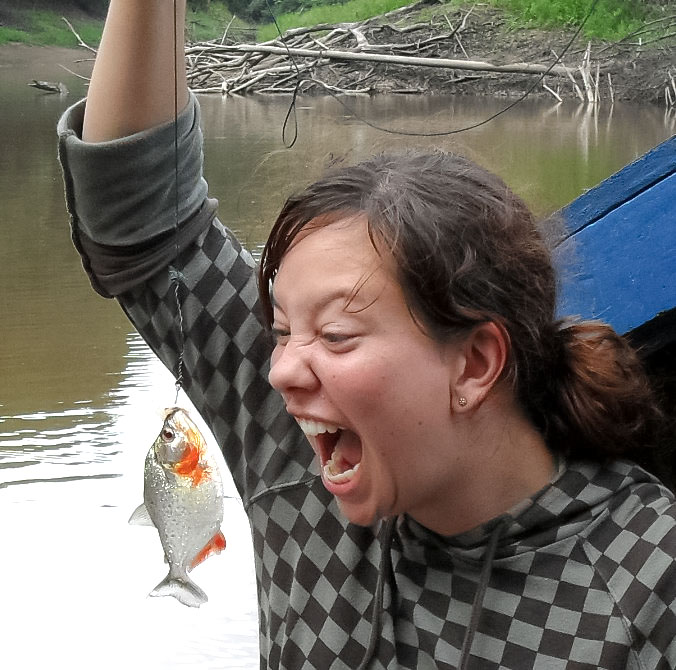 A visitor reacting to a rainforest insect during an Amazon wildlife exploration tour.
