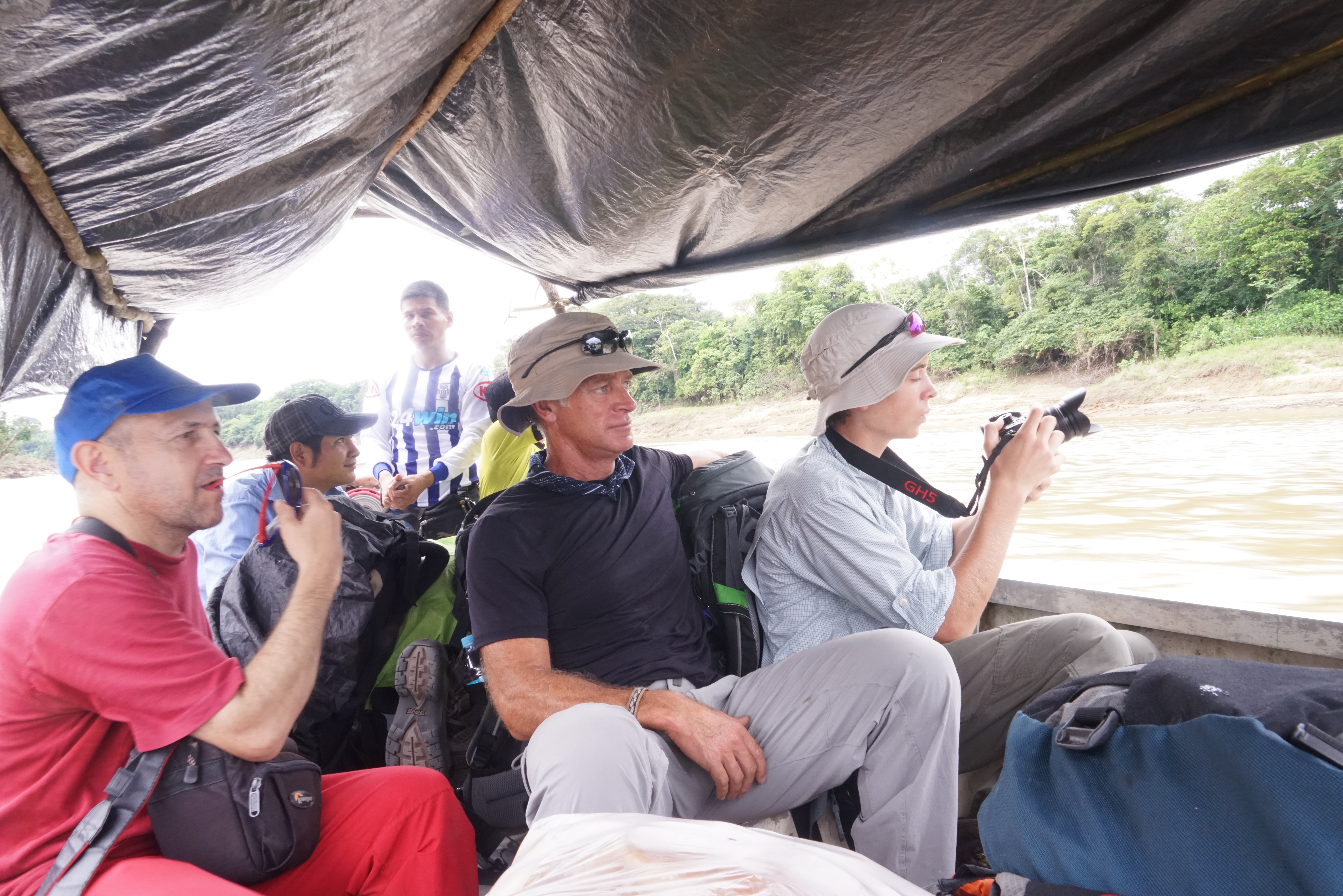Visitors are traveling by boat through Amazon rainforest rivers during a guided jungle tour in Peru.