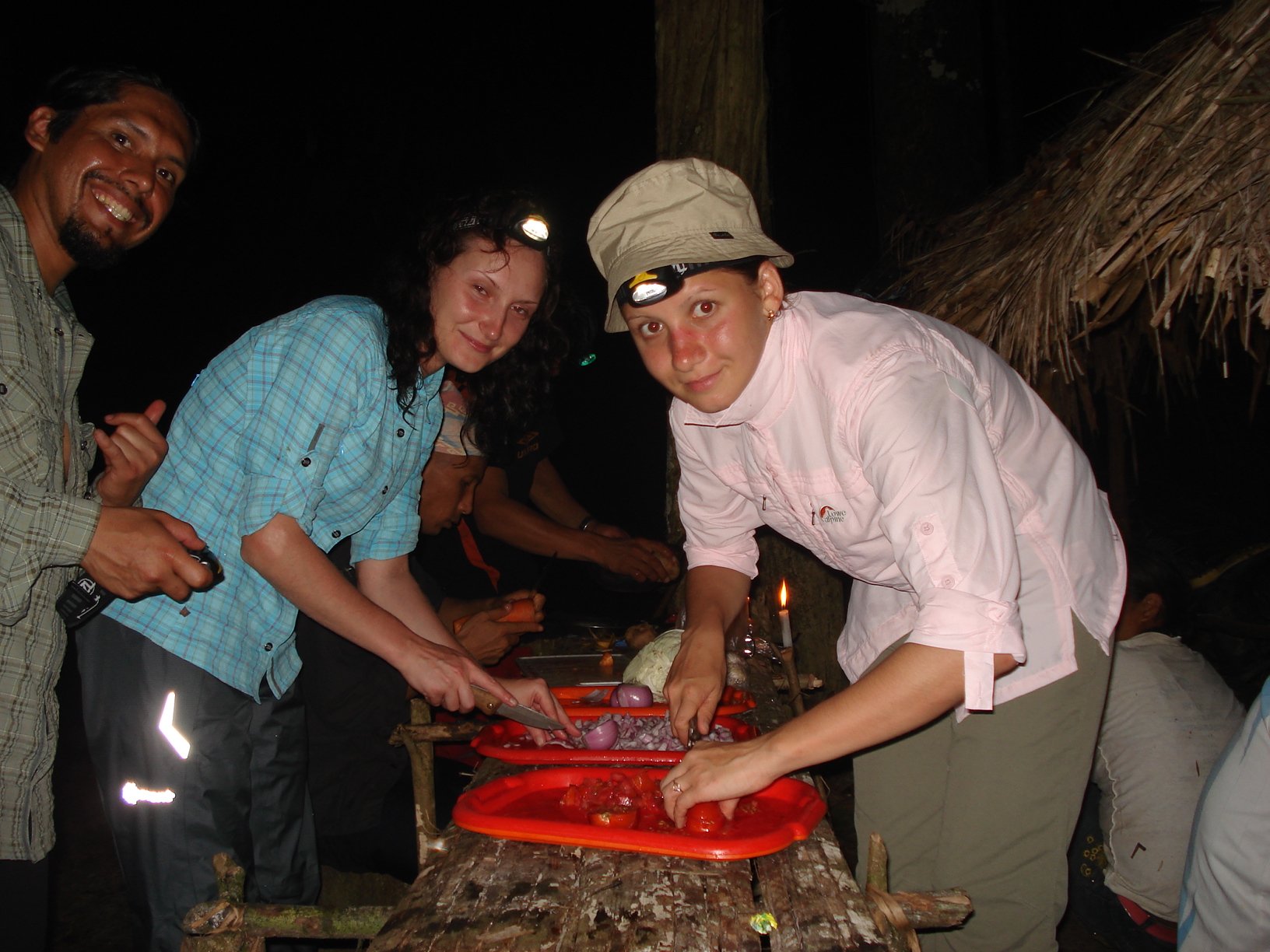 Visitors preparing food with a local guide during an Amazon cultural experience in Peru.