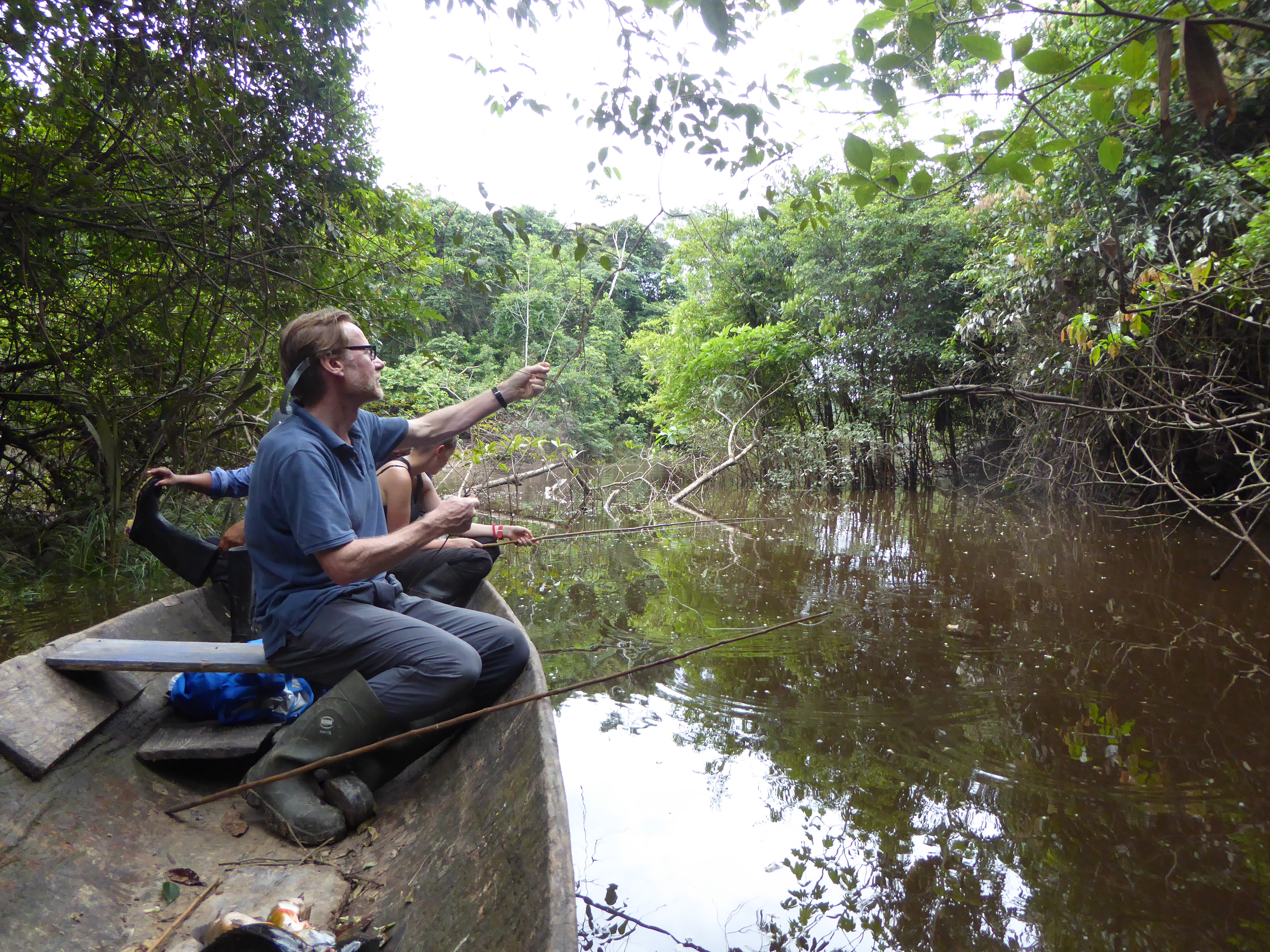 Visitors exploring a flooded forest by canoe during an Amazon rainforest tour near Selva Wild Lodge in Peru.